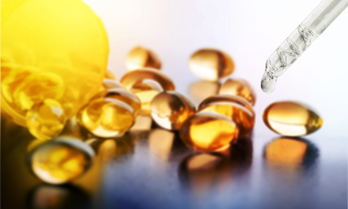 CBD oil capsules beside a glass bottle